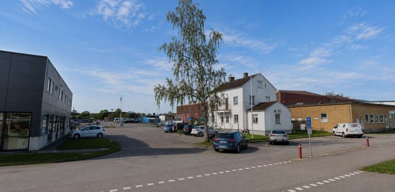 Bilder av en stadsdel i Kalmar med parkeringsplatser och byggnader.