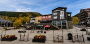 Fasad av en modern byggnad i Åre med träd och berg i bakgrunden.