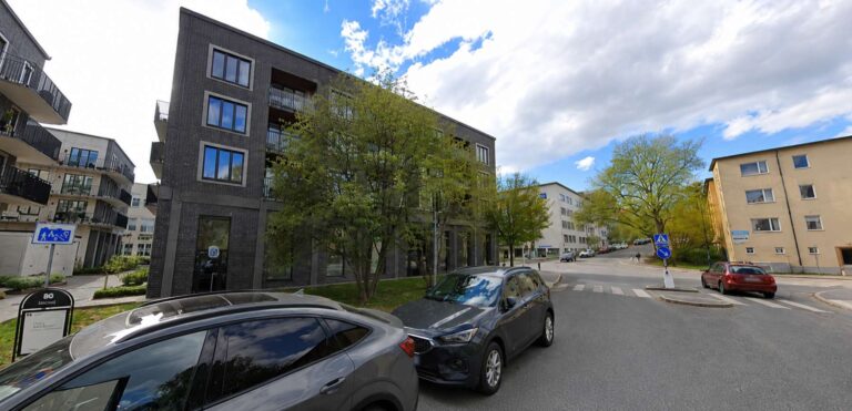 Modern kontorsbyggnad vid en gata i Stockholm.