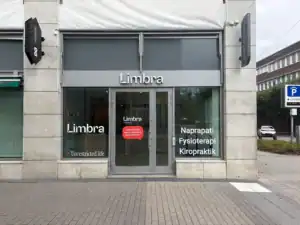 Limbra klinikens entré med skyltar för naprapati, fysioterapi och kiropraktik.